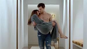 Dakota Johnson as Anastasia Steele and Jamie Dornan as Christian Grey in Fifty Shades of Grey