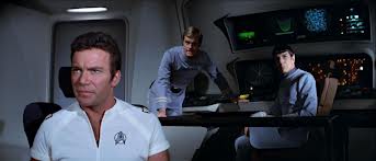 William Shatner, Stephen Collins, and Leonard Nimoy staring at the view screen in Star Trek: The Motion Picture
